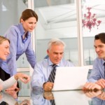 photo by Ambros of office workers in a meeting at Adventures in Expat Land